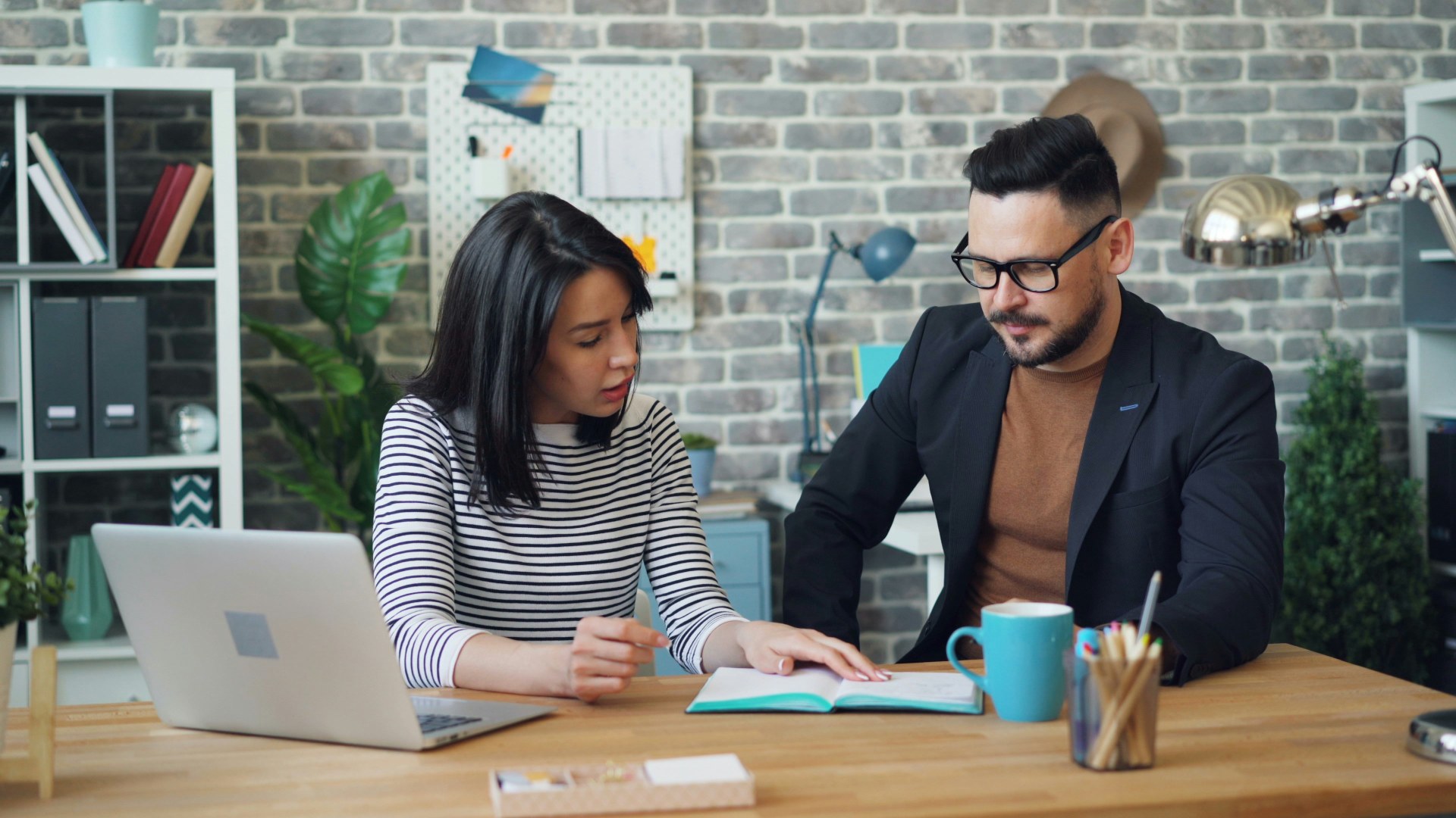 Two professionals reviewing a document at a desk