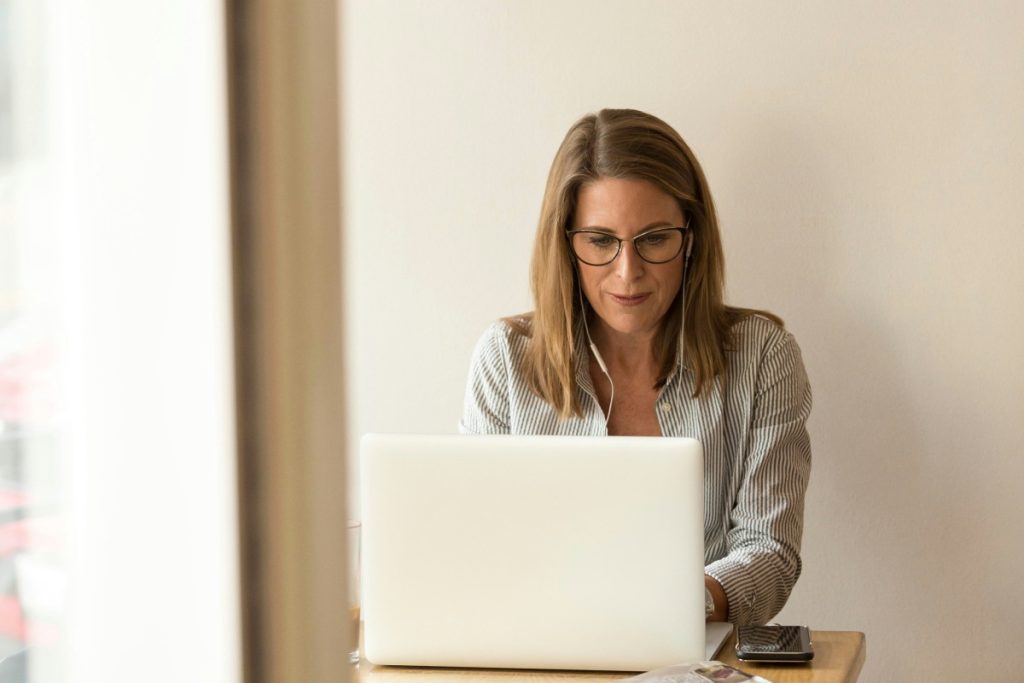 Woman working on a laptop in a bright room