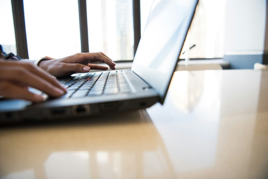 Person typing on laptop